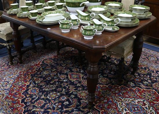 An Edwardian walnut wind-out dining table, one extra leaf, L.148cm